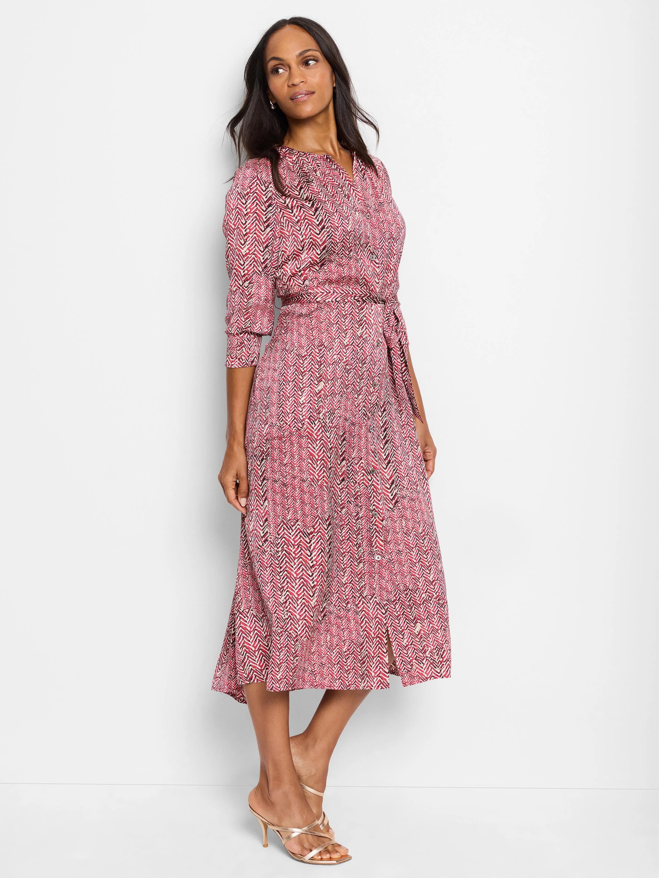 Red midi dress with a herringbone pattern in black and white. Three-quarter sleeves, belted waist, and a front button...