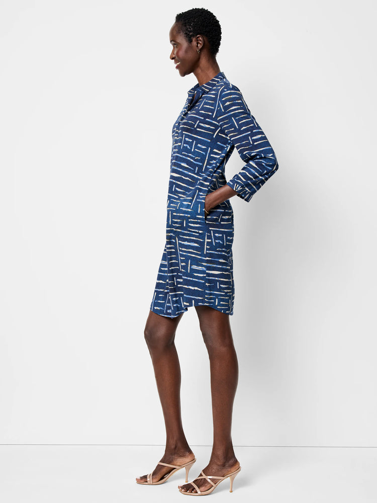 Indigo blue shirt dress with a beige and white abstract linear print. Three-quarter sleeves, collared neckline.