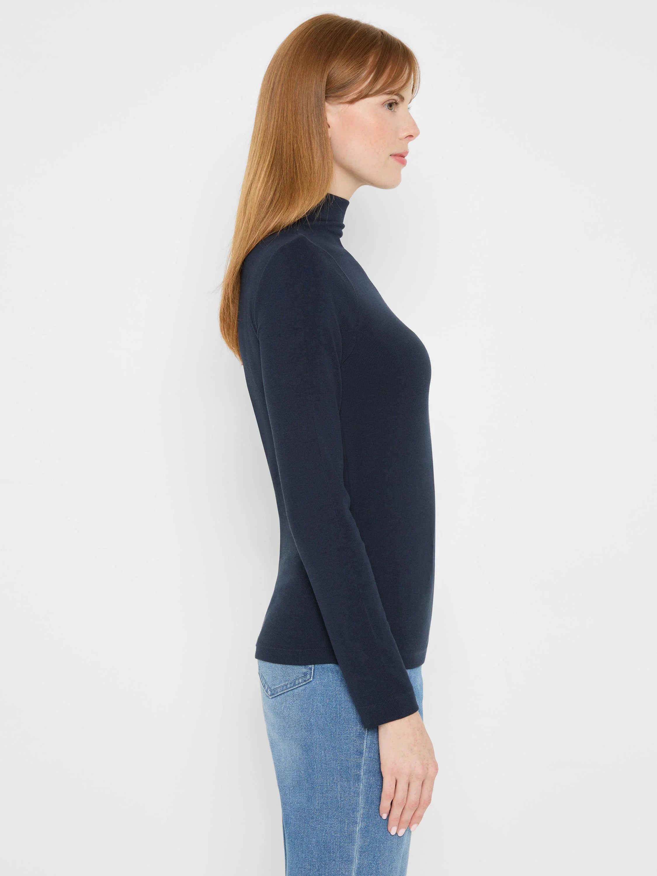 Close-fitting navy rib knit long sleeve mock neck tee.
