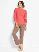 Coral thermal knit top with a round neck, long sleeves, and 4 gold buttons along the left shoulder.