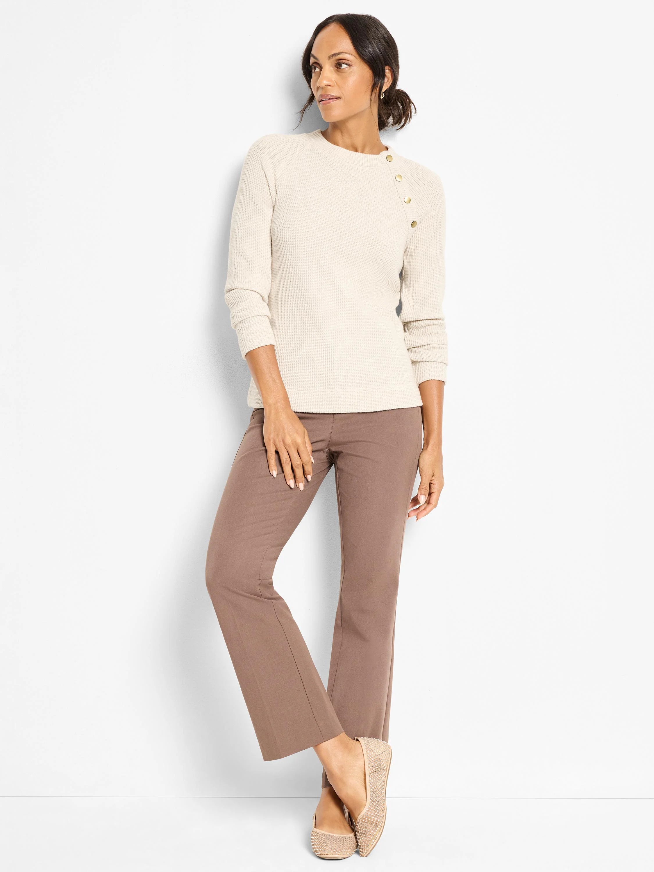 Cream ribbed thermal top with round neck and three gold buttons vertically on the left shoulder.