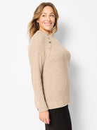 Beige waffle knit thermal top with long sleeves, ribbed cuffs, and three gold buttons on the left shoulder.
