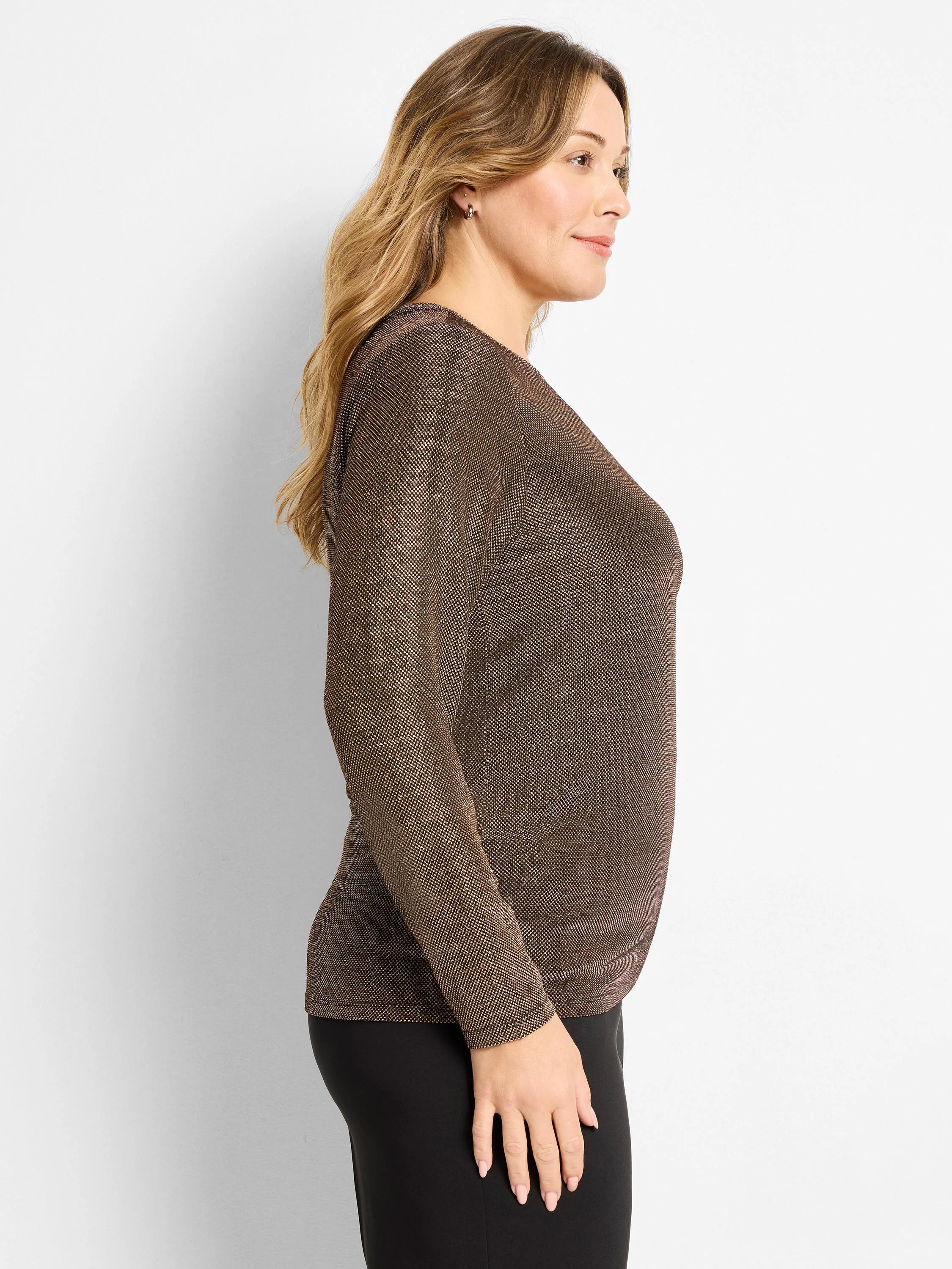 Long-sleeved knit top, dark bronze with dense, shimmering gold flecks. Worn by a woman in profile.