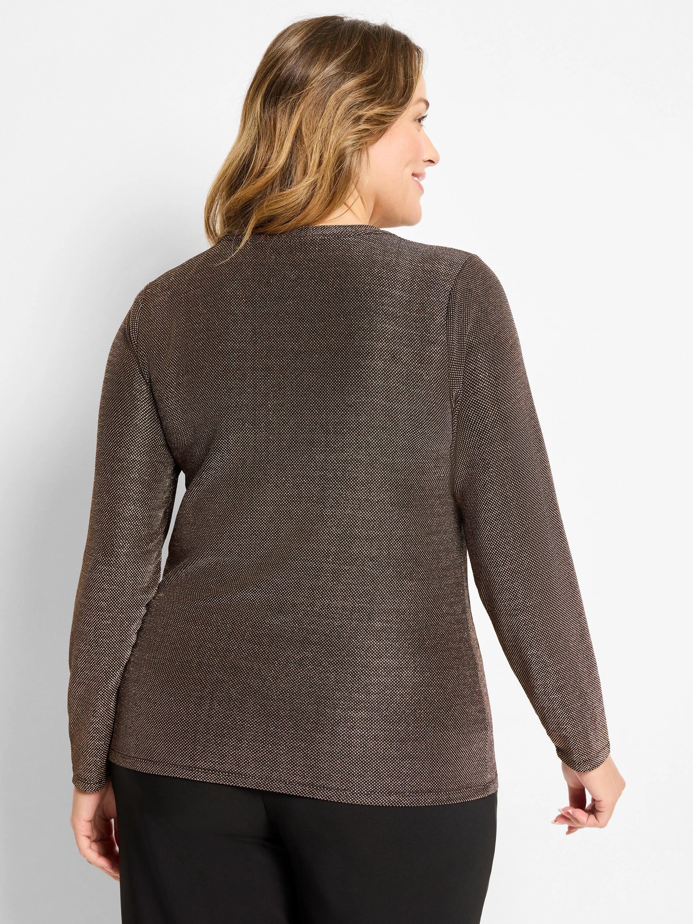 Woman in dark brown long-sleeve knit top with subtle metallic flecks, viewed from the back.