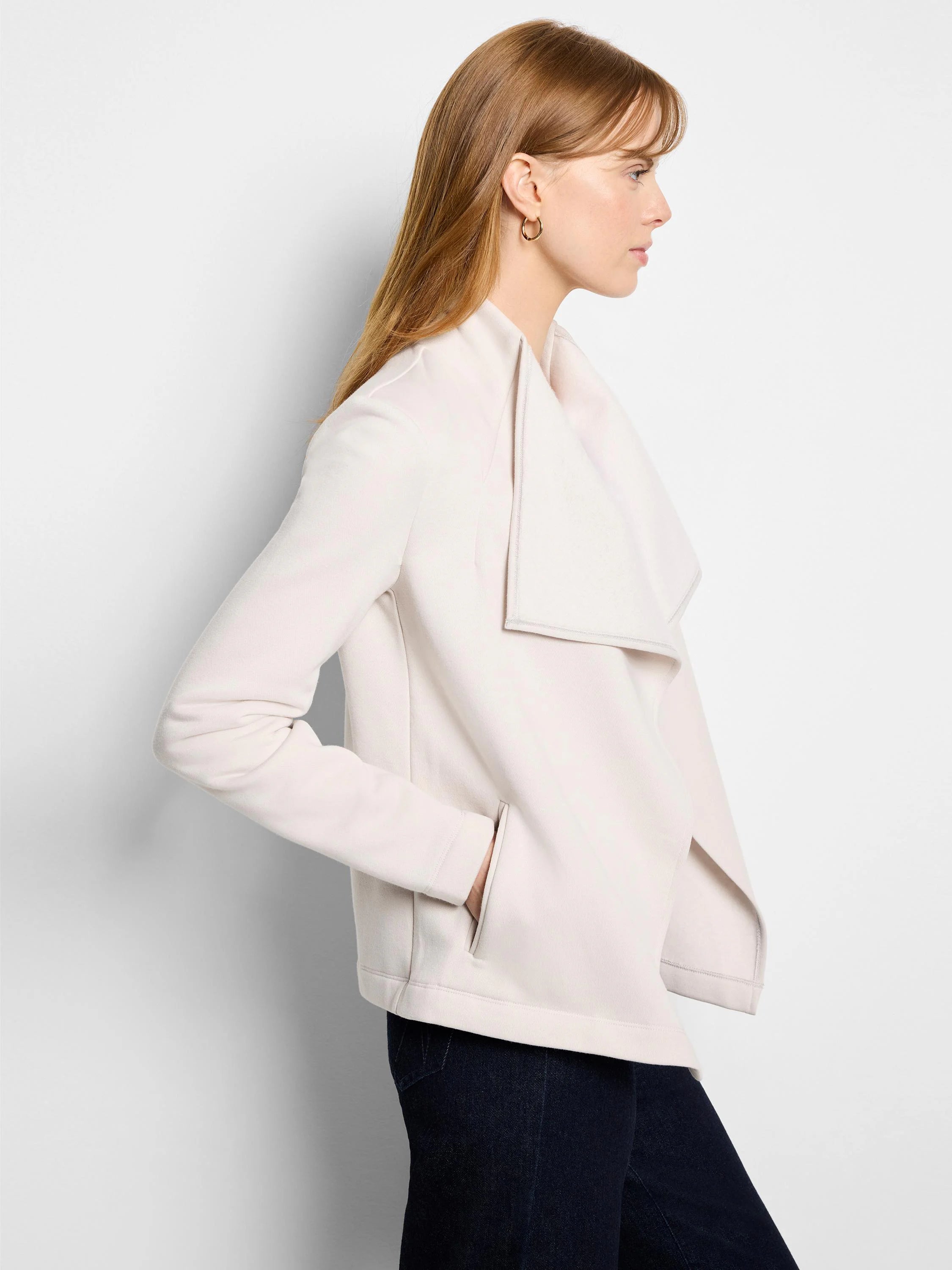 Light beige jacket with an asymmetrical open front and a wide, draped collar. Features side pockets.