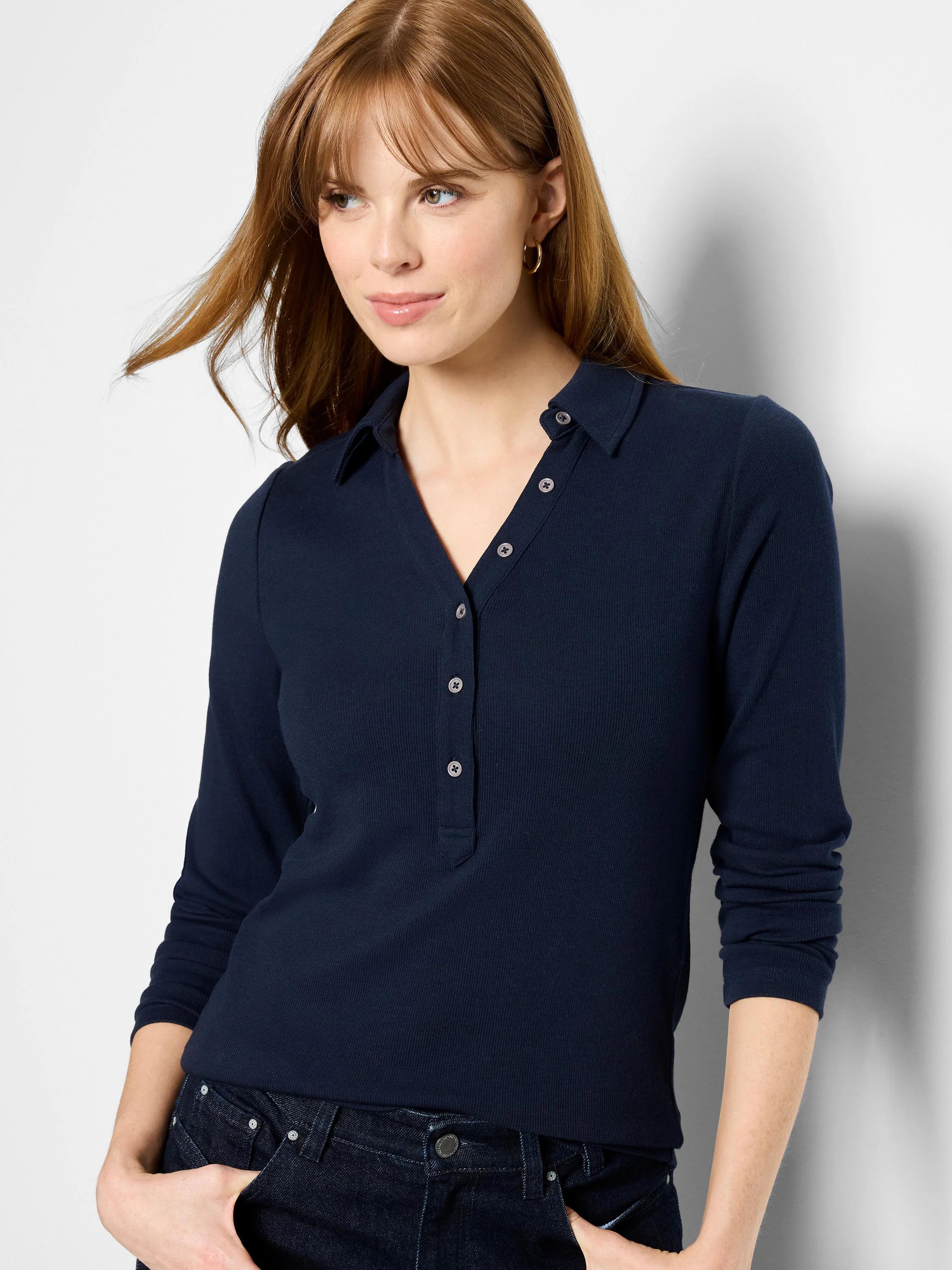 Navy ribbed knit polo with collar, V-neck, long sleeves, and a white button placket.