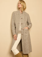 Long, collarless sherpa tweed knit topcoat in heathered tan and cream with brown buttons and patch pockets.