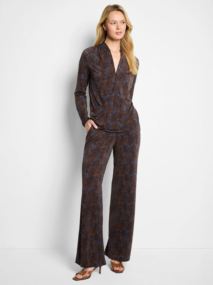 V-neck long-sleeve wrap top, brown fern print on blue. Shown with matching wide-leg pants.