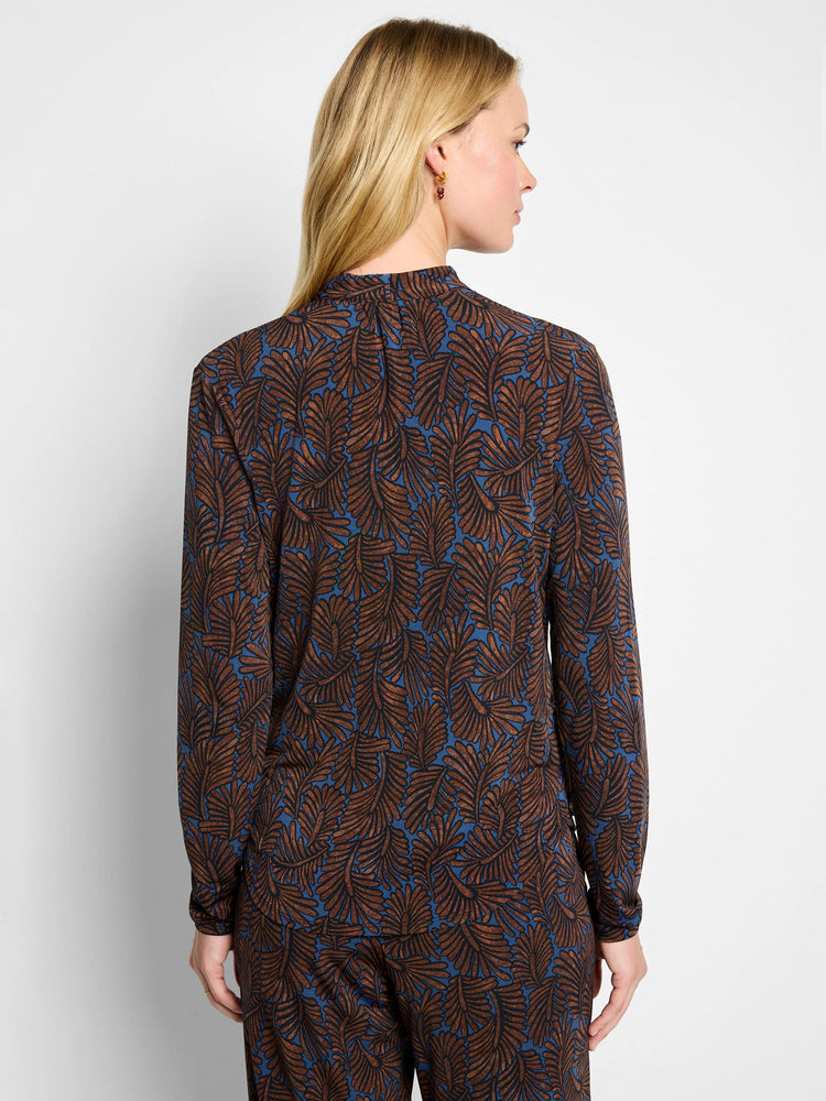Long-sleeved top with brown and black feather fern pattern on a blue background.