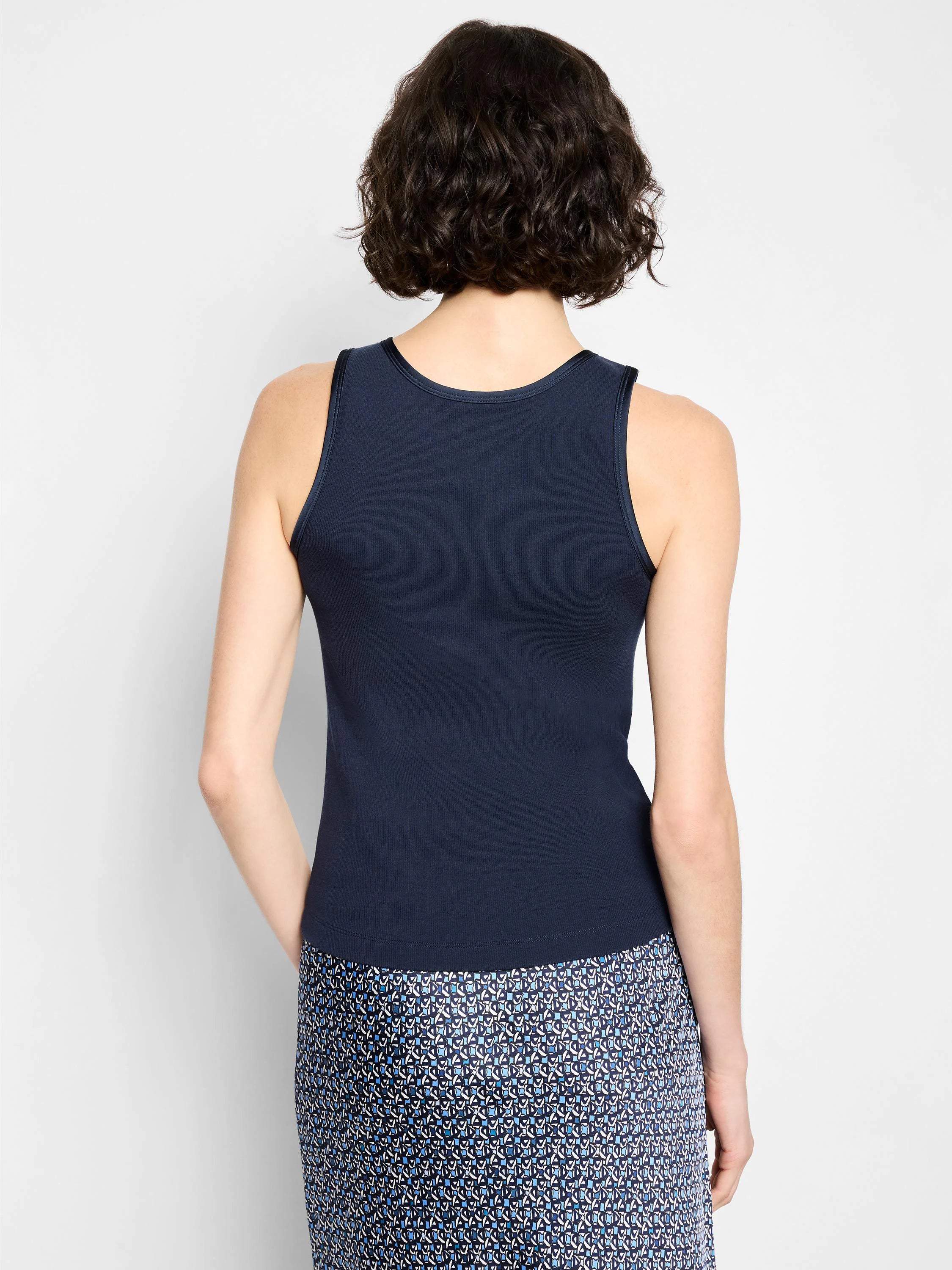 Navy blue ribbed knit tank top, back view, with a round neck and dark trim.