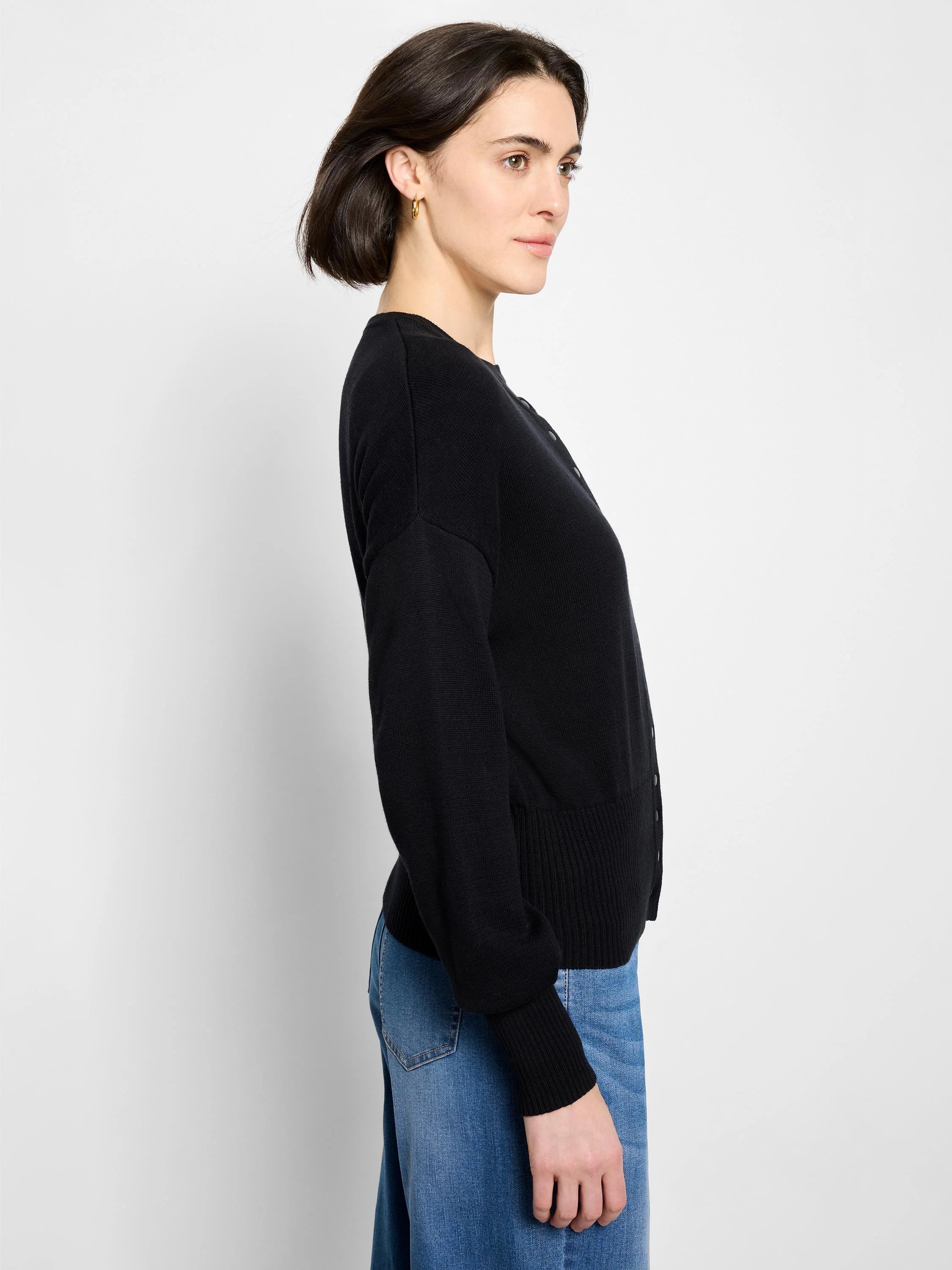 Black crew neck cardigan with dark button-front closure, ribbed cuffs and hem.