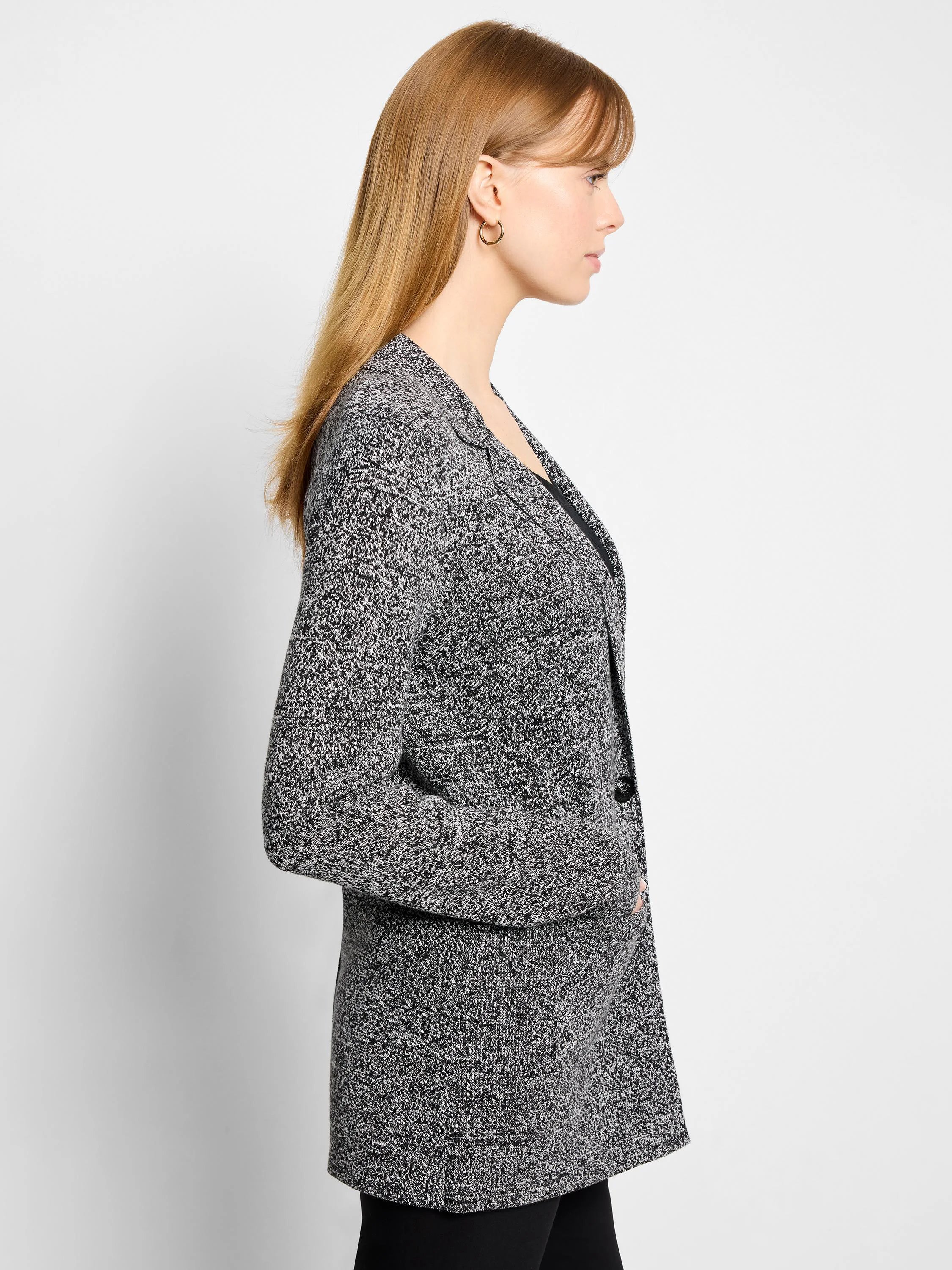 Black and white speckled knit blazer with notched lapels and a single-button closure, shown on a model.