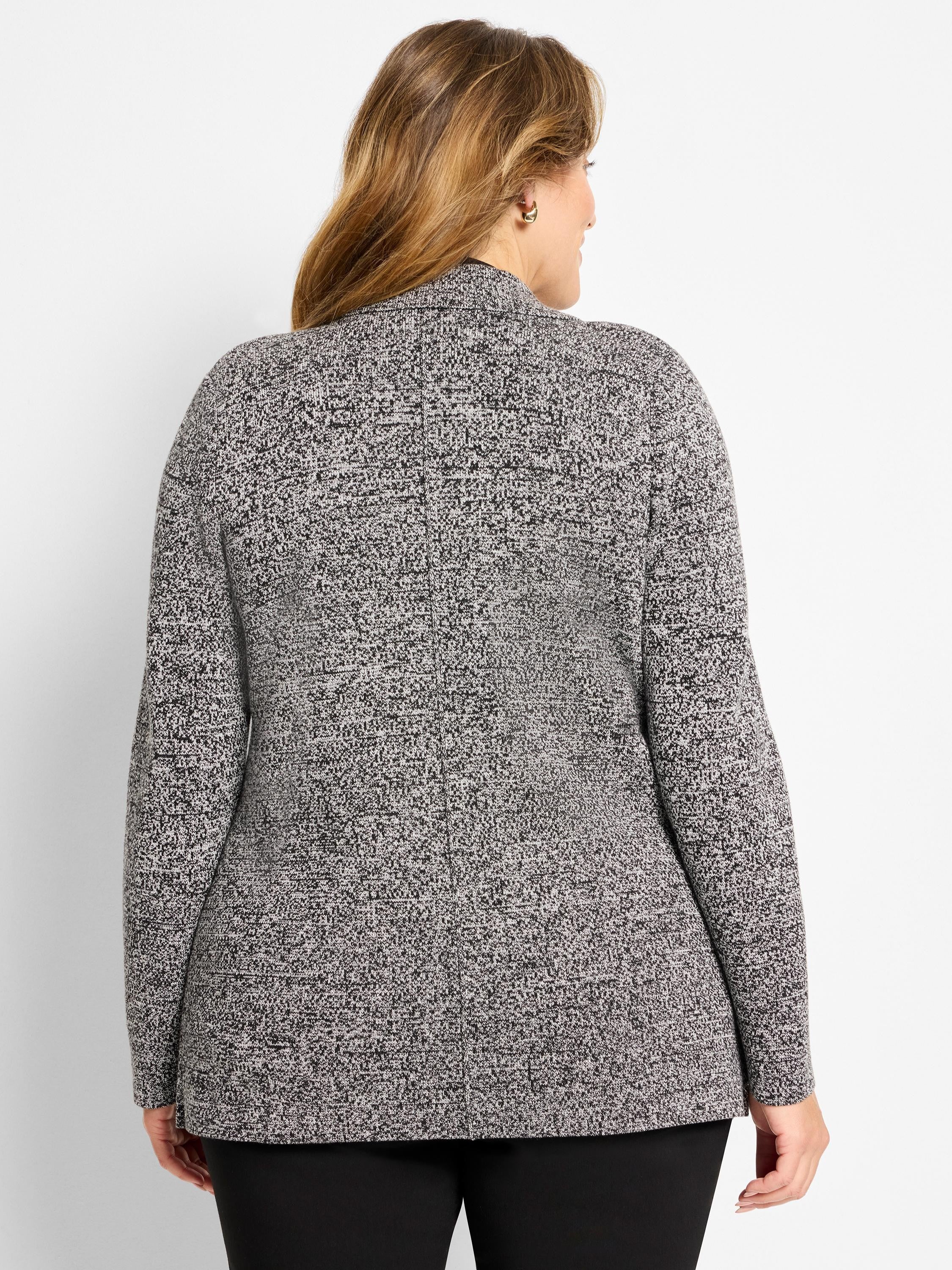 Black and white speckled knit blazer with long sleeves, shown from the back, reaching the upper thigh.