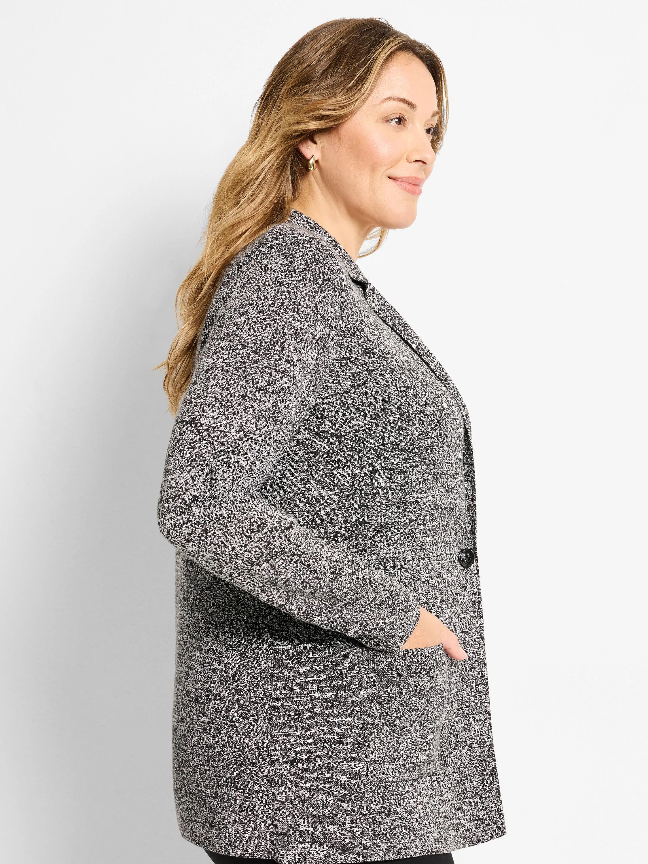 Black and white speckled knit blazer with lapels, a single button, and side pockets.