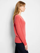 Coral V-neck sweater with a textured tuck stitch knit. Features long sleeves and ribbed cuffs and hem.