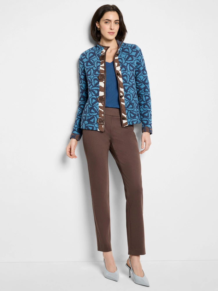 Blue quilted jacket with abstract pattern, brown trim, white placket detail, and brown buttons.