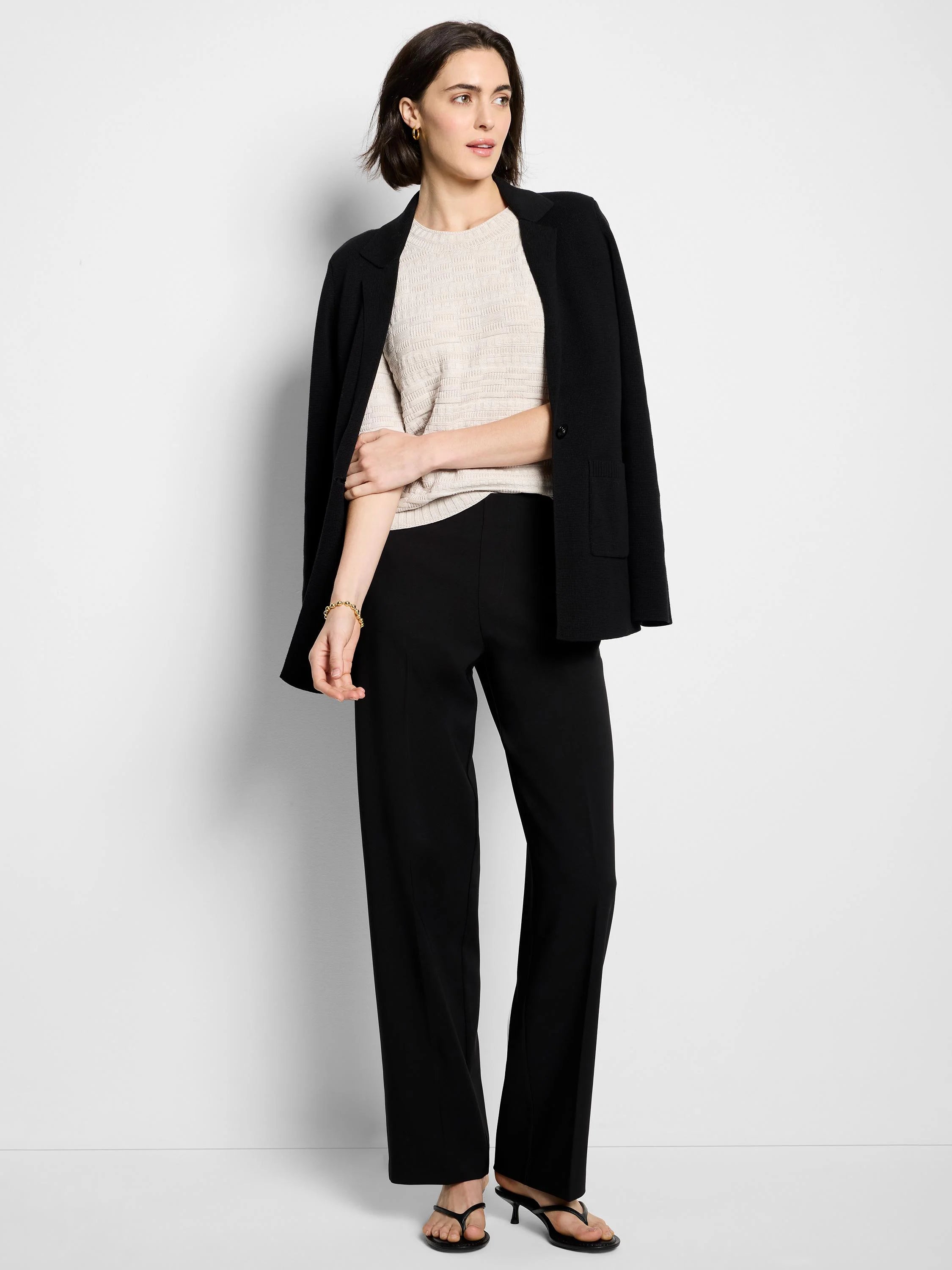 Light cream short-sleeve sweater tee with a subtle, raised knit texture and round neck.