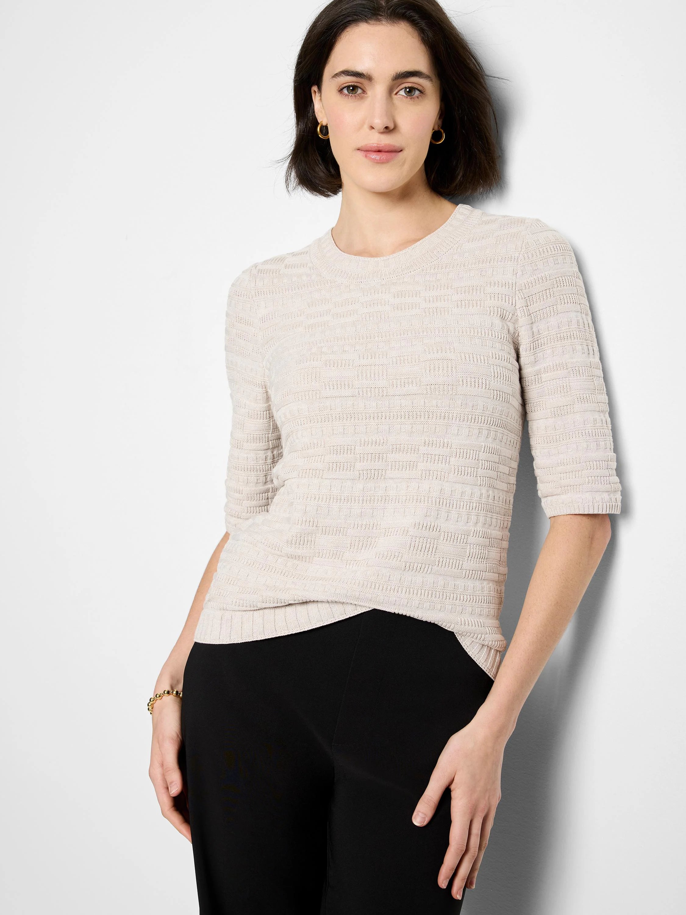 Pale beige sweater tee with a geometric textured knit, crew neck, and elbow-length sleeves.