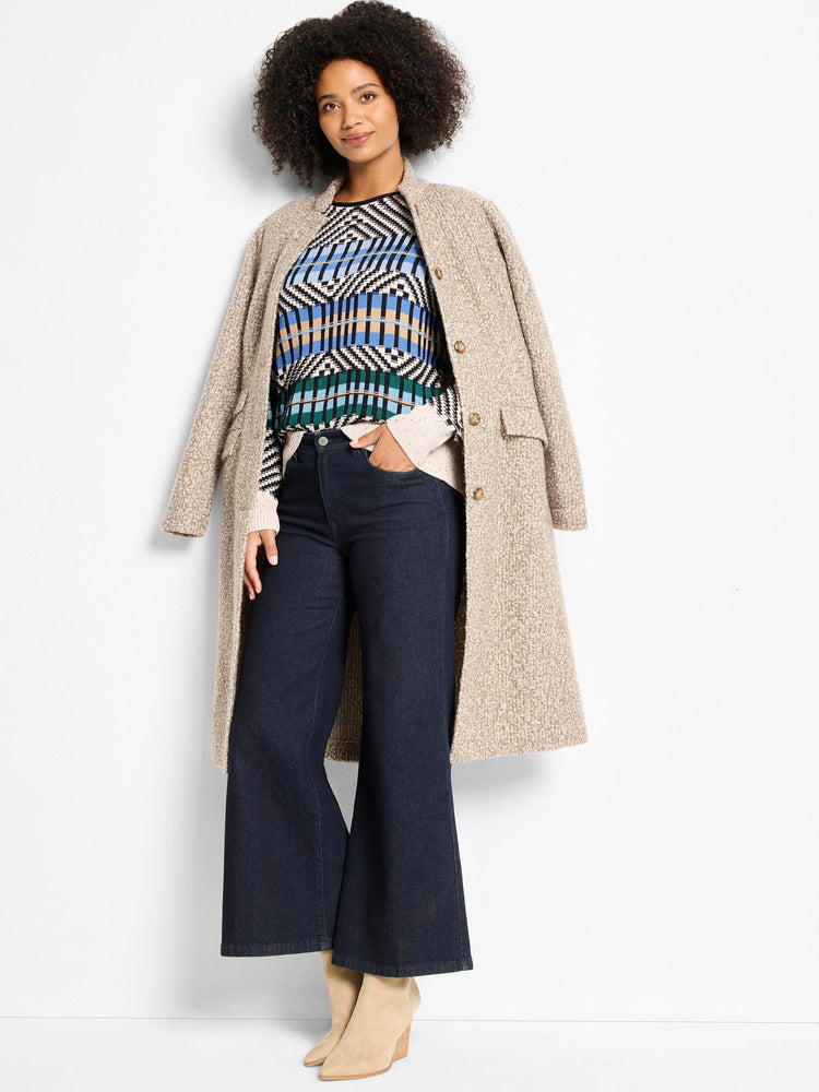 Graphic sweater with geometric patterns in black, white, blue, green, and tan stripes.