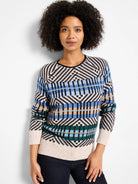Sweater with black, off-white, blue, tan, and green geometric patterns, including chevrons and varied stripes. Crew neck.