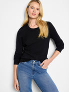 Black fine knit crew neck sweater with long sleeves, ribbed cuffs and hem.