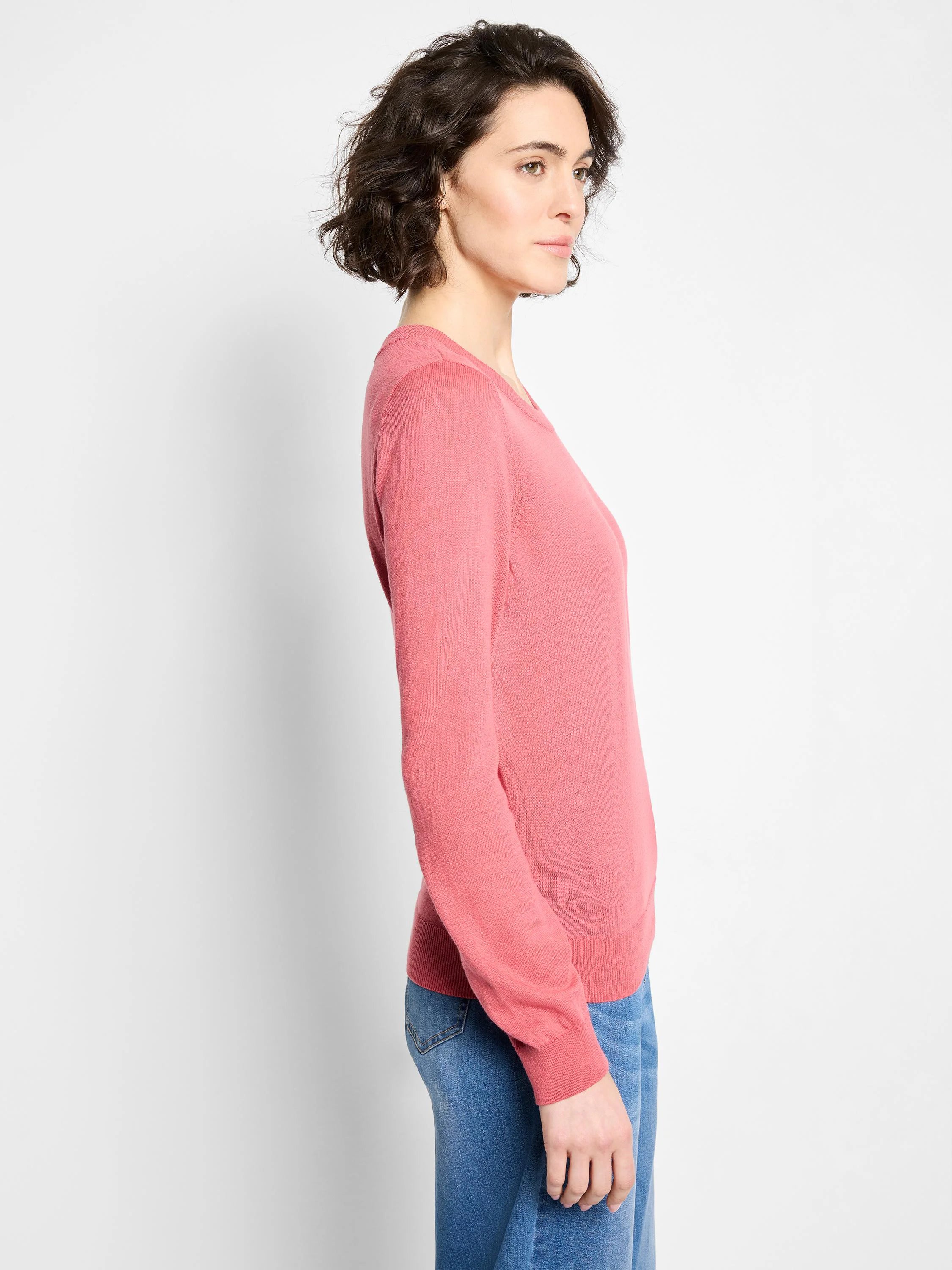 Muted pink crew neck sweater with long sleeves, ribbed cuffs and hem. Relaxed fit shown on model.