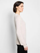 Oatmeal crew neck sweater, long sleeves with ribbed cuffs and hem, worn by a model.