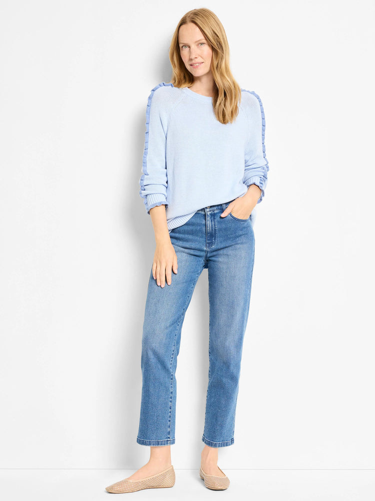 Pale blue knit sweater with ruffles extending down the shoulders and sleeves.