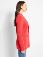Red knit blazer with white contrast stitching on lapels, shoulders, & pockets. Features dark buttons.