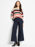 Speckled knit sweater with horizontal beige, navy, white, and coral stripes.