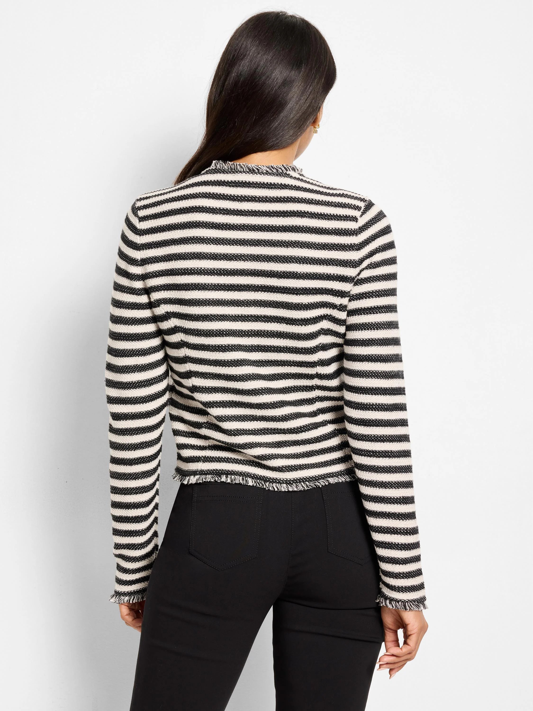 Black and cream horizontally striped knit jacket with fringe at the neckline, cuffs, and hem. Back view.