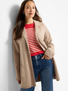 Long beige plaited knit cardigan coat with a blazer collar and patch pockets.