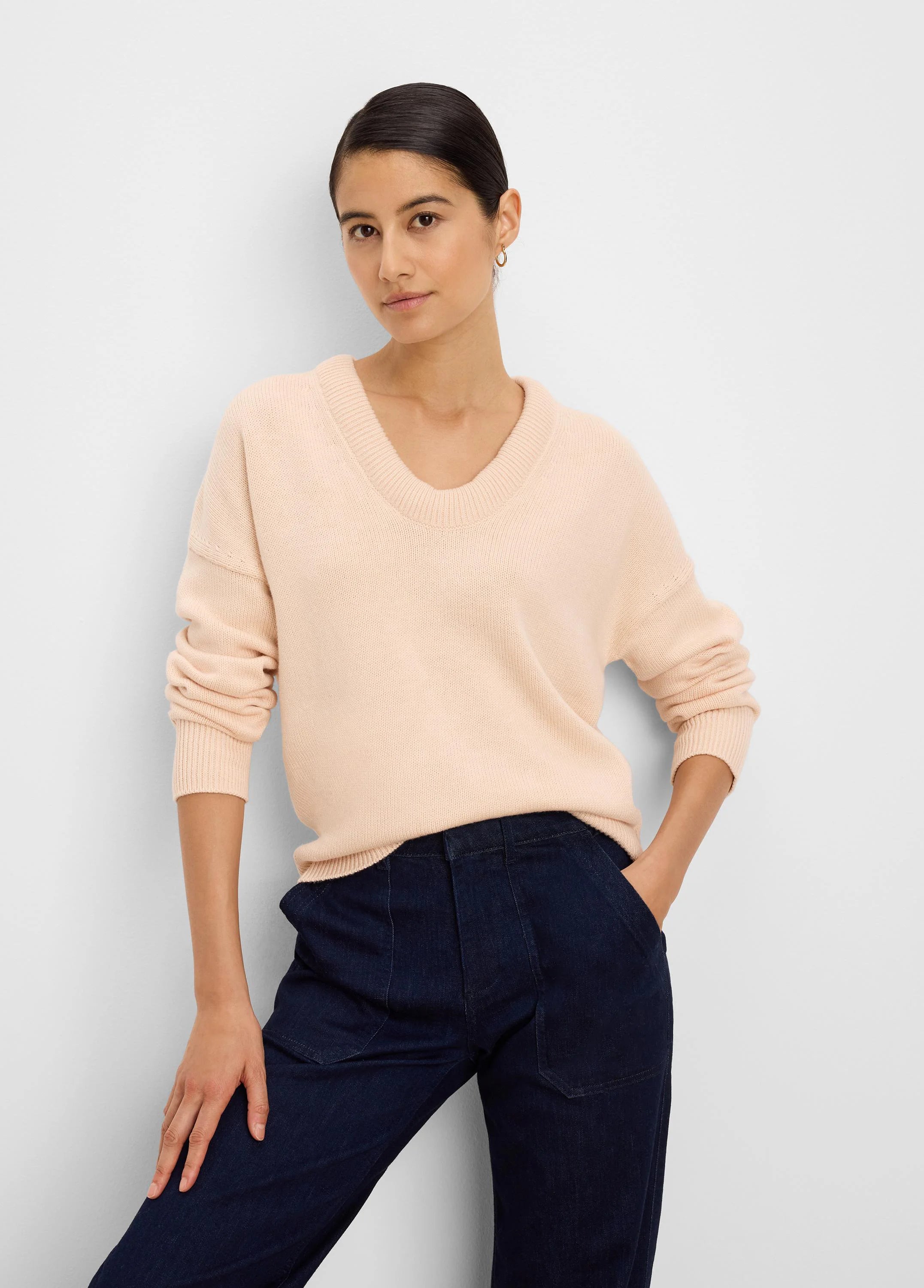 Light pinkish-beige cotton cashmere sweater with a ribbed scoop neck and cuffs.