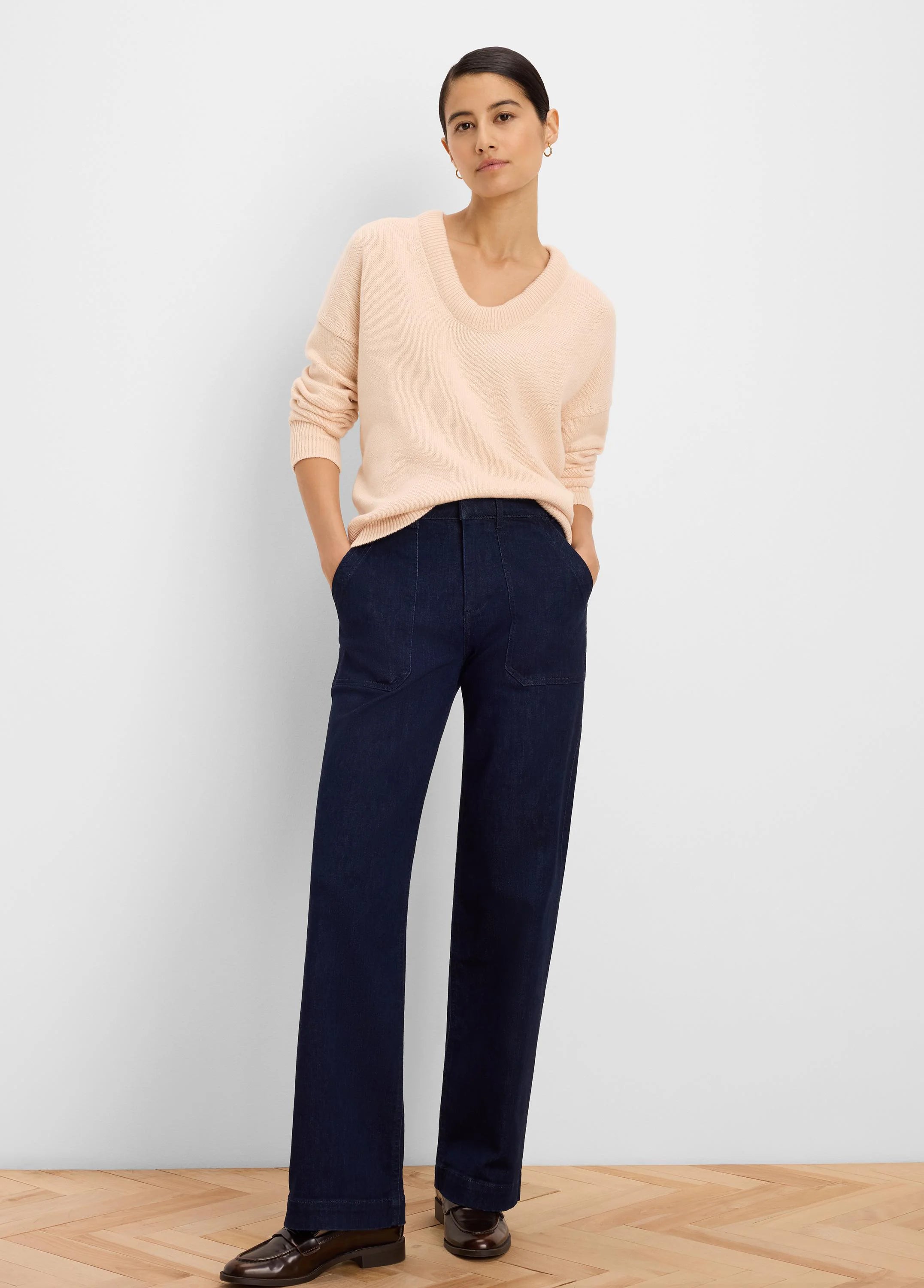 Light peach knit sweater with a relaxed fit and scoop neck.