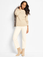 Light beige sweater with textural dot patterns across the chest and shoulders.