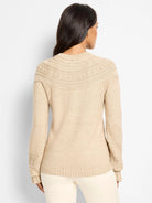 Beige sweater with a textured dot pattern on its rounded yoke and sleeve cuffs, shown from the back.