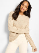 Beige crewneck sweater with textural dot pattern on the yoke and cuffs.