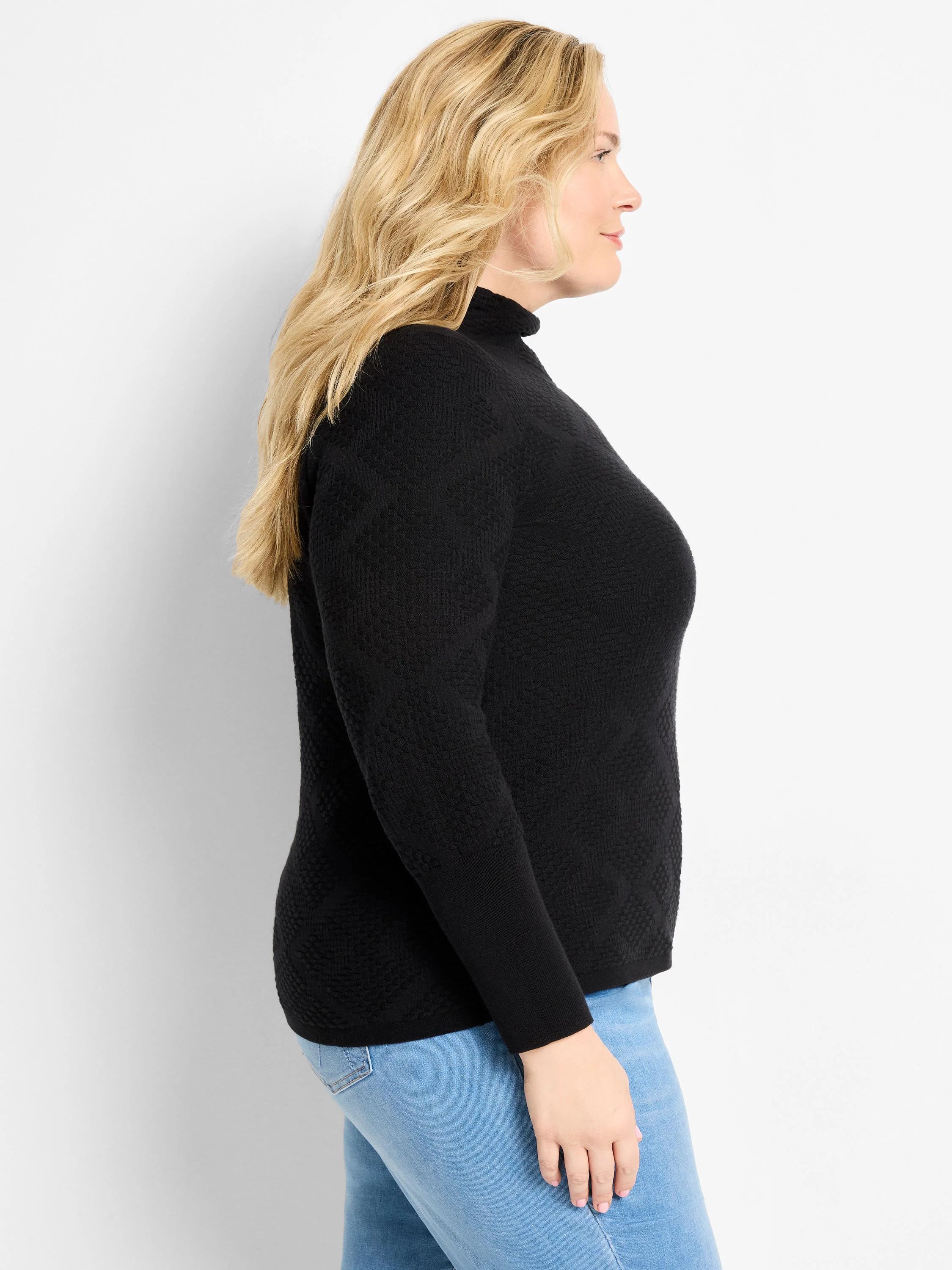 Black turtleneck sweater with a textured diamond pattern.