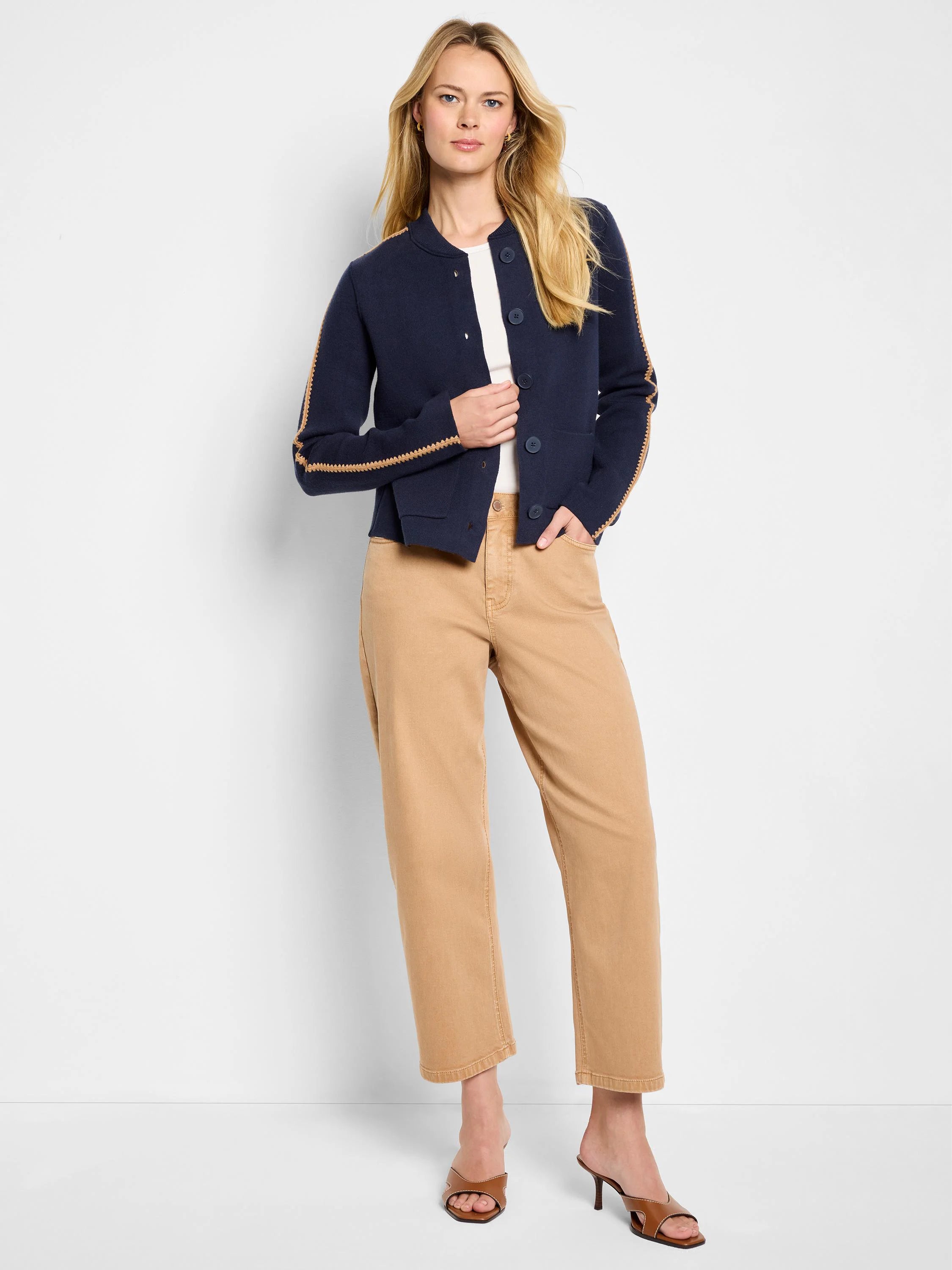 Navy knit bomber jacket with round neck, button front, and tan zig-zag stitching detail on shoulders and sleeves.