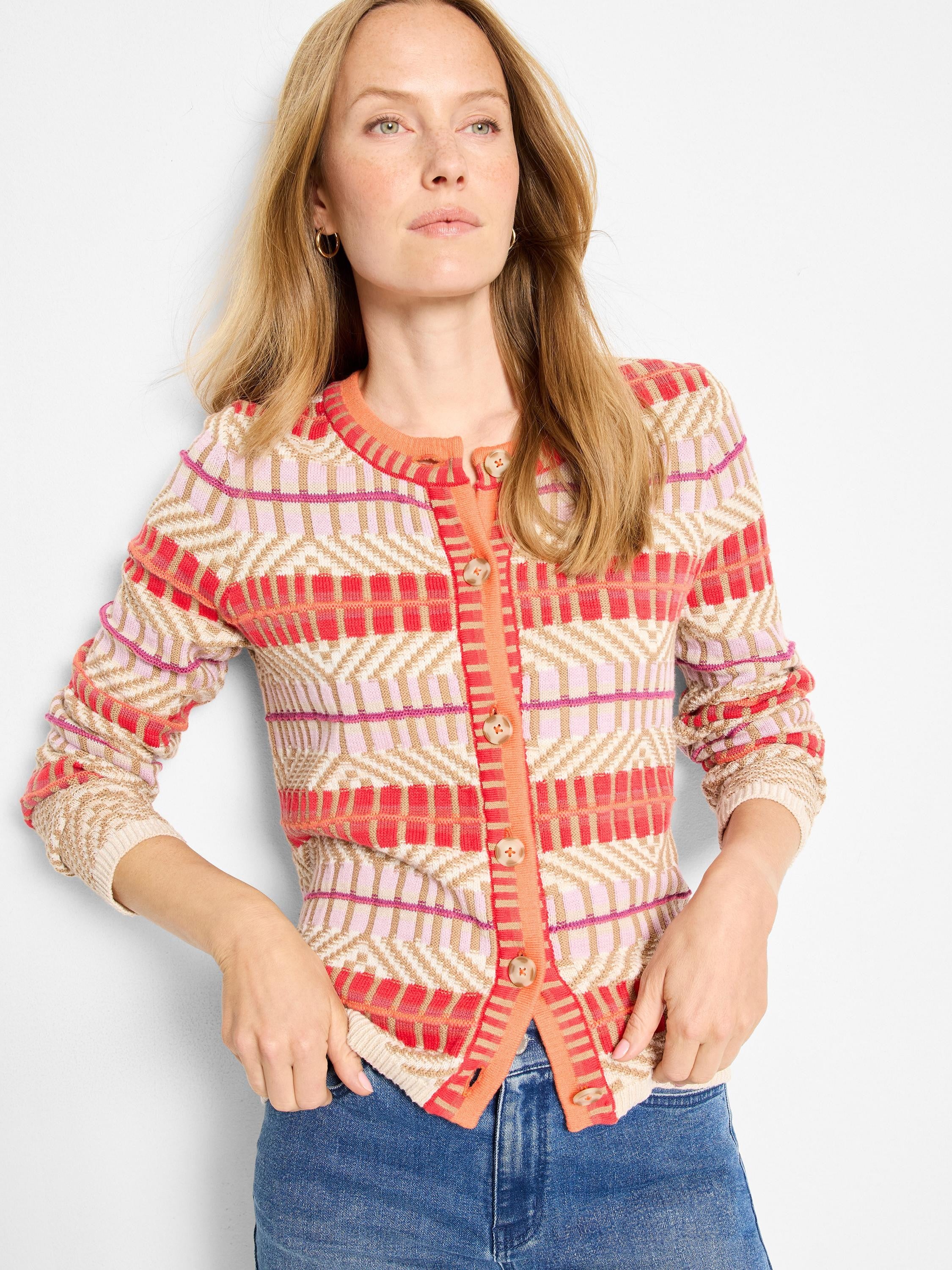 Multi-color geometric knit cardigan in red, pink, orange, and beige, with front buttons.