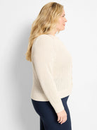 Cream open-knit button-front cardigan with long sleeves, ribbed cuffs, and ribbed hem.