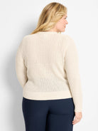 Cream long-sleeve open-knit sweater with ribbed cuffs and hem.