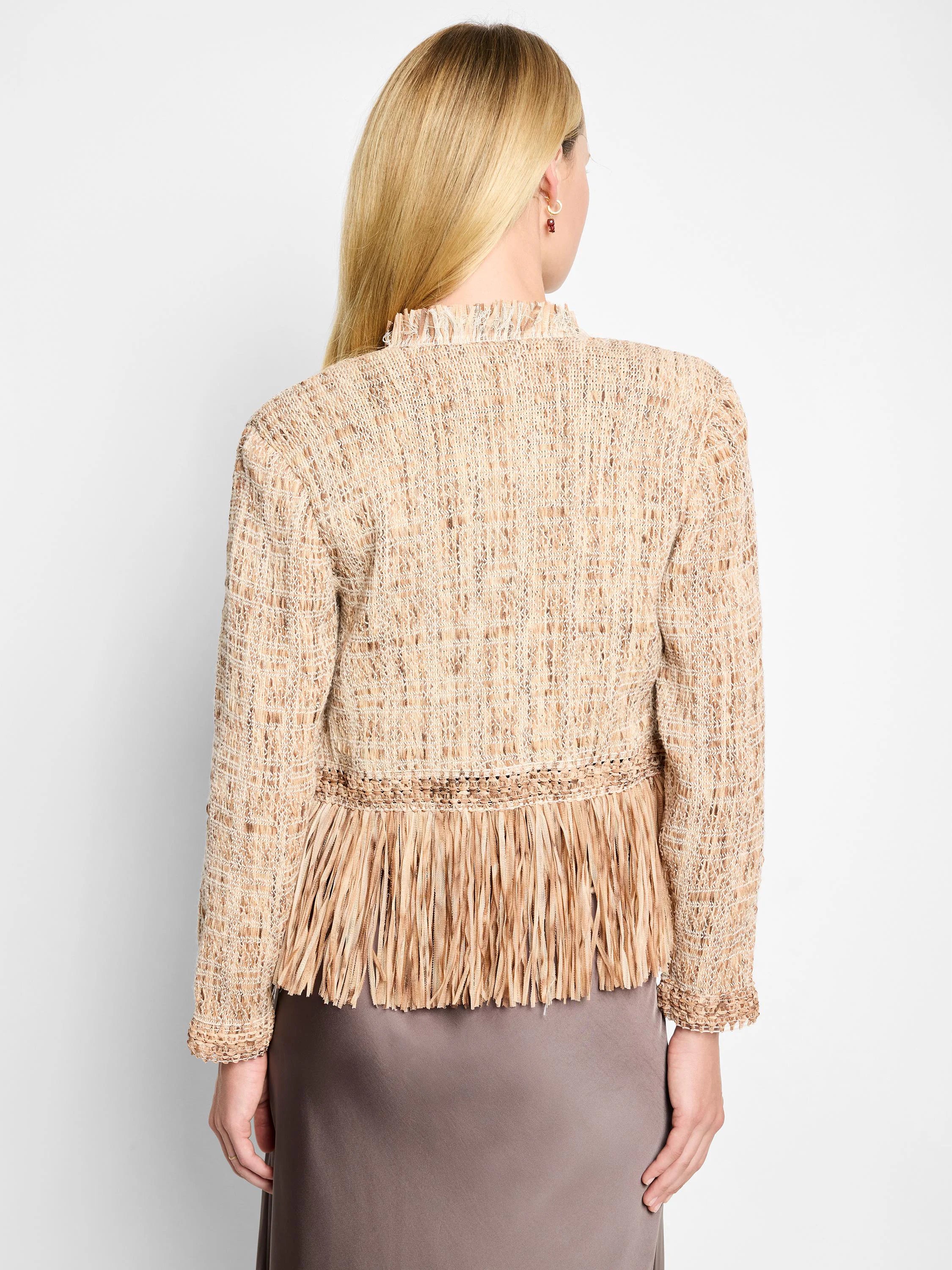 Beige knit jacket with a textured weave and long fringe at the hem. The fringe is a similar beige/brown shade.