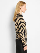 Black and beige zebra print cardigan on a model, shown from the side.