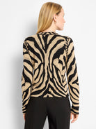 Black and tan zebra print jacquard knit cardigan, modeled from the back.