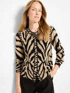 Black and tan zebra jacquard cardigan with a collar and gold buttons down the front.