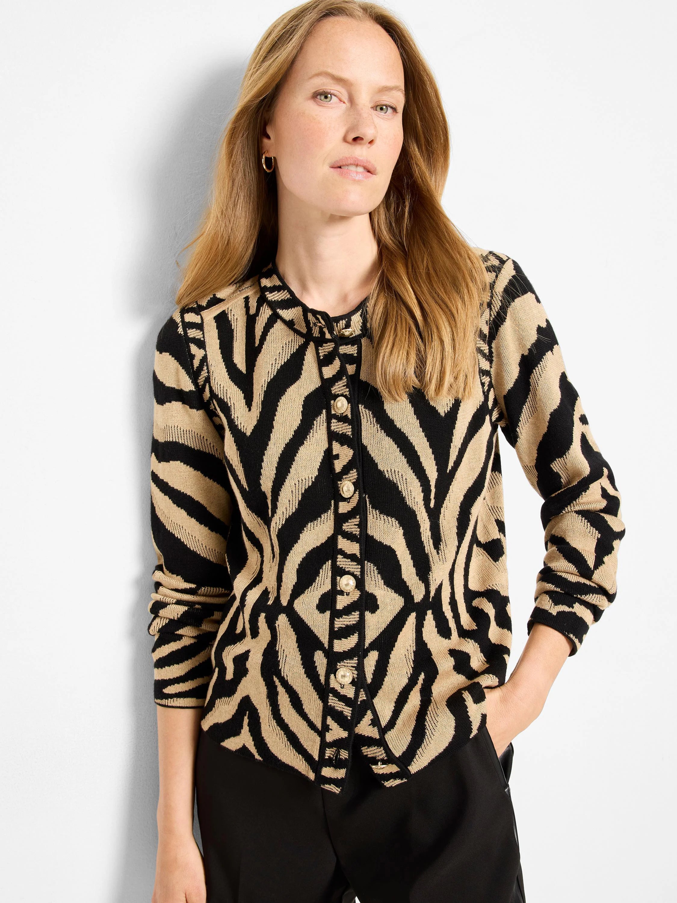 Black and tan zebra jacquard cardigan with a collar and gold buttons down the front.