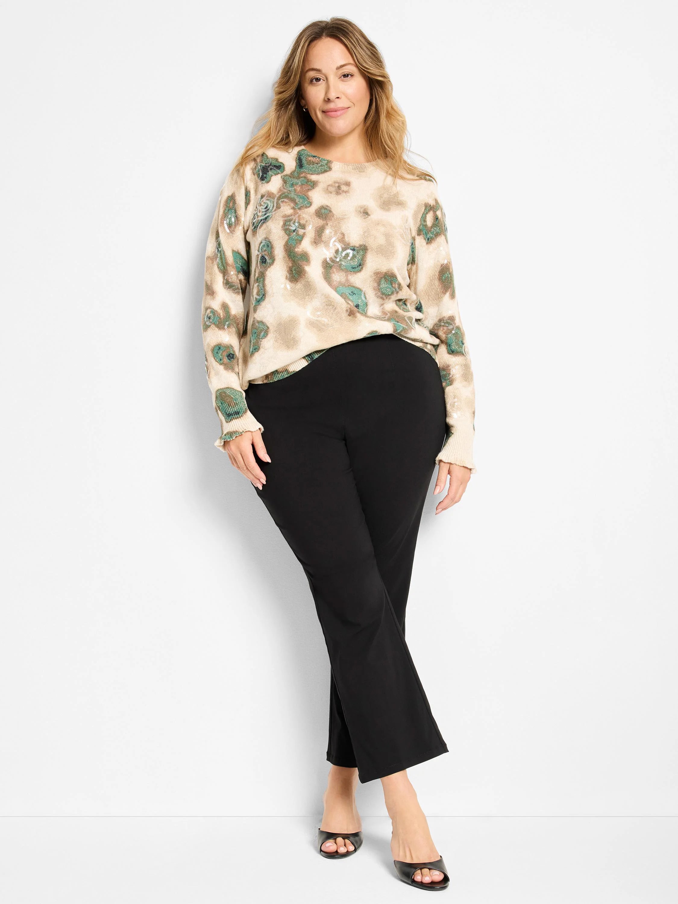 Beige long-sleeve sweater with green and brown camo pattern and scattered sequins.