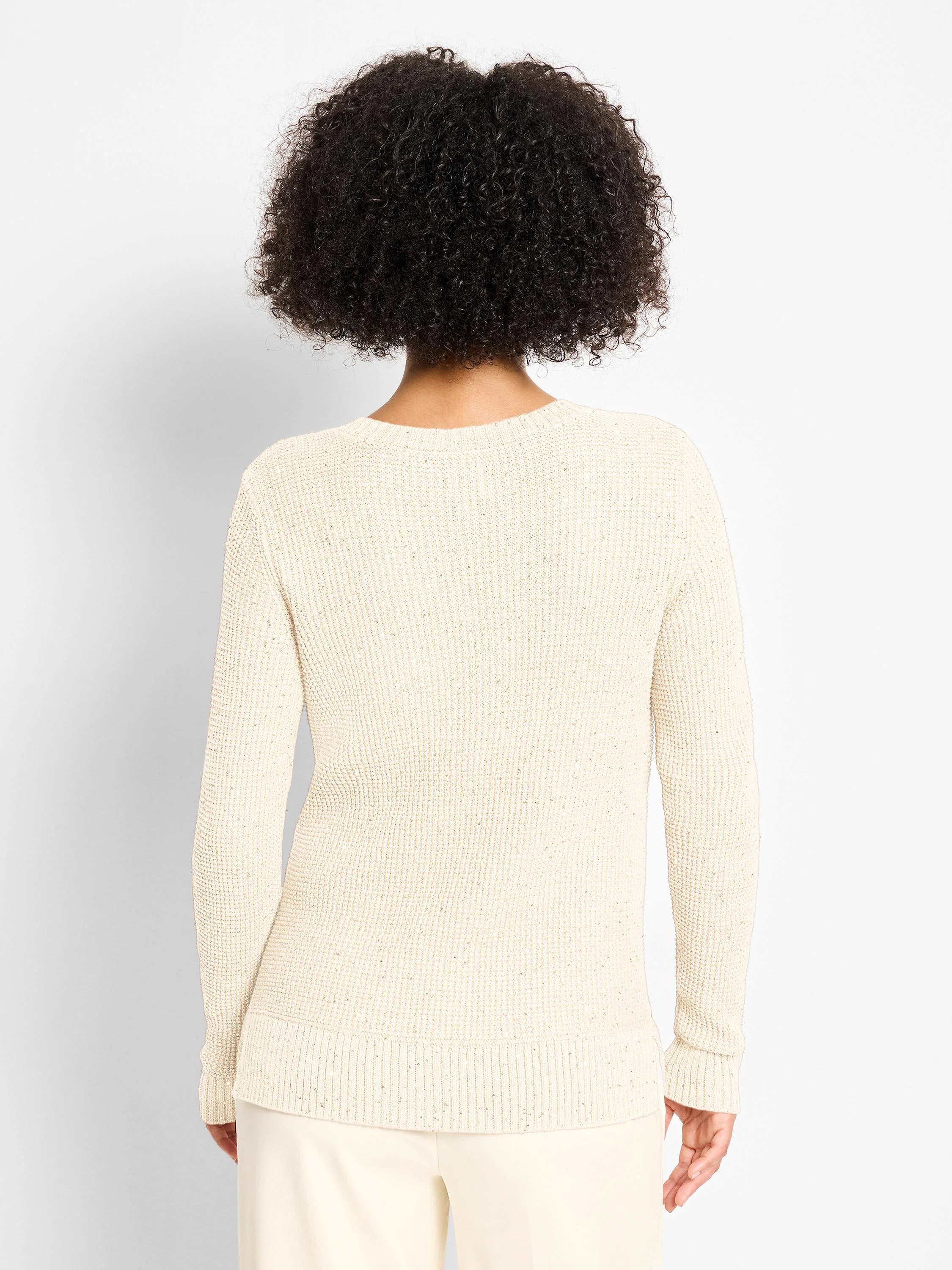 Back view of a cream waffle-knit sweater with subtle shimmer. Long-sleeved with ribbed cuffs and hem. V-neck not visible.