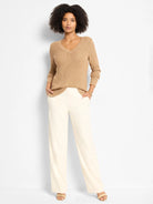 Tan shimmer waffle V-neck sweater with long sleeves.